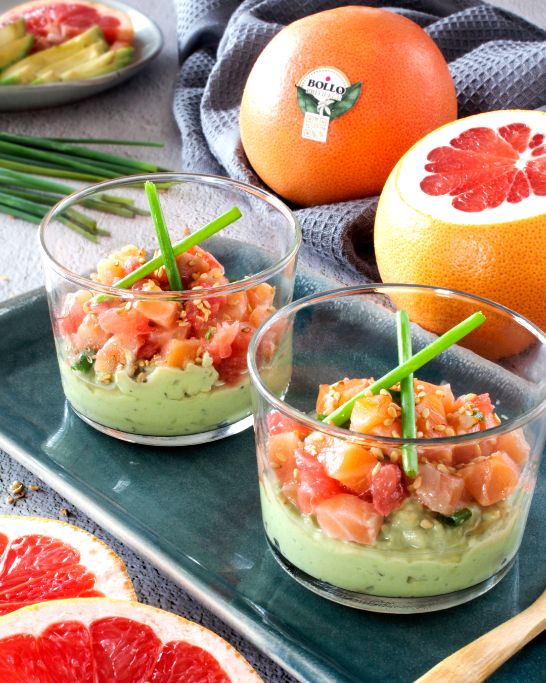Glasses of avocado with salmon and grapefruit tartar